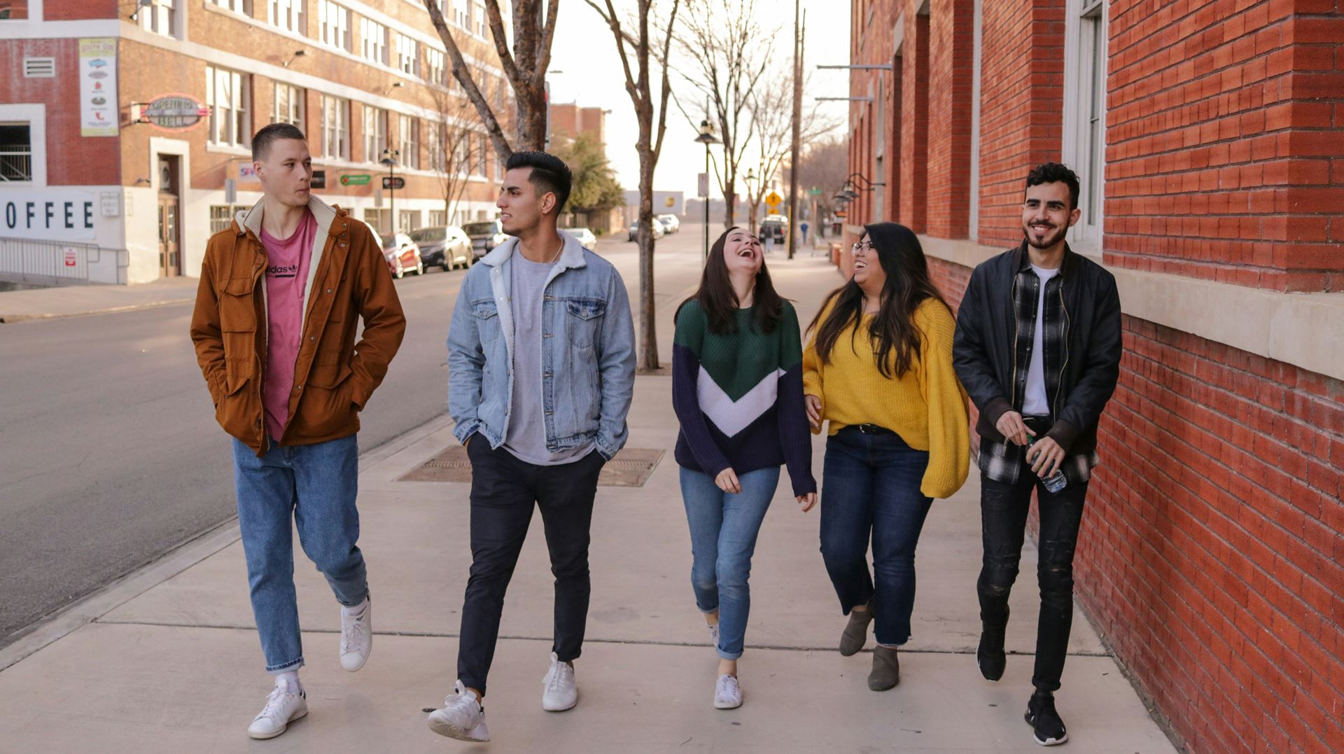 Group of young people walking along a street