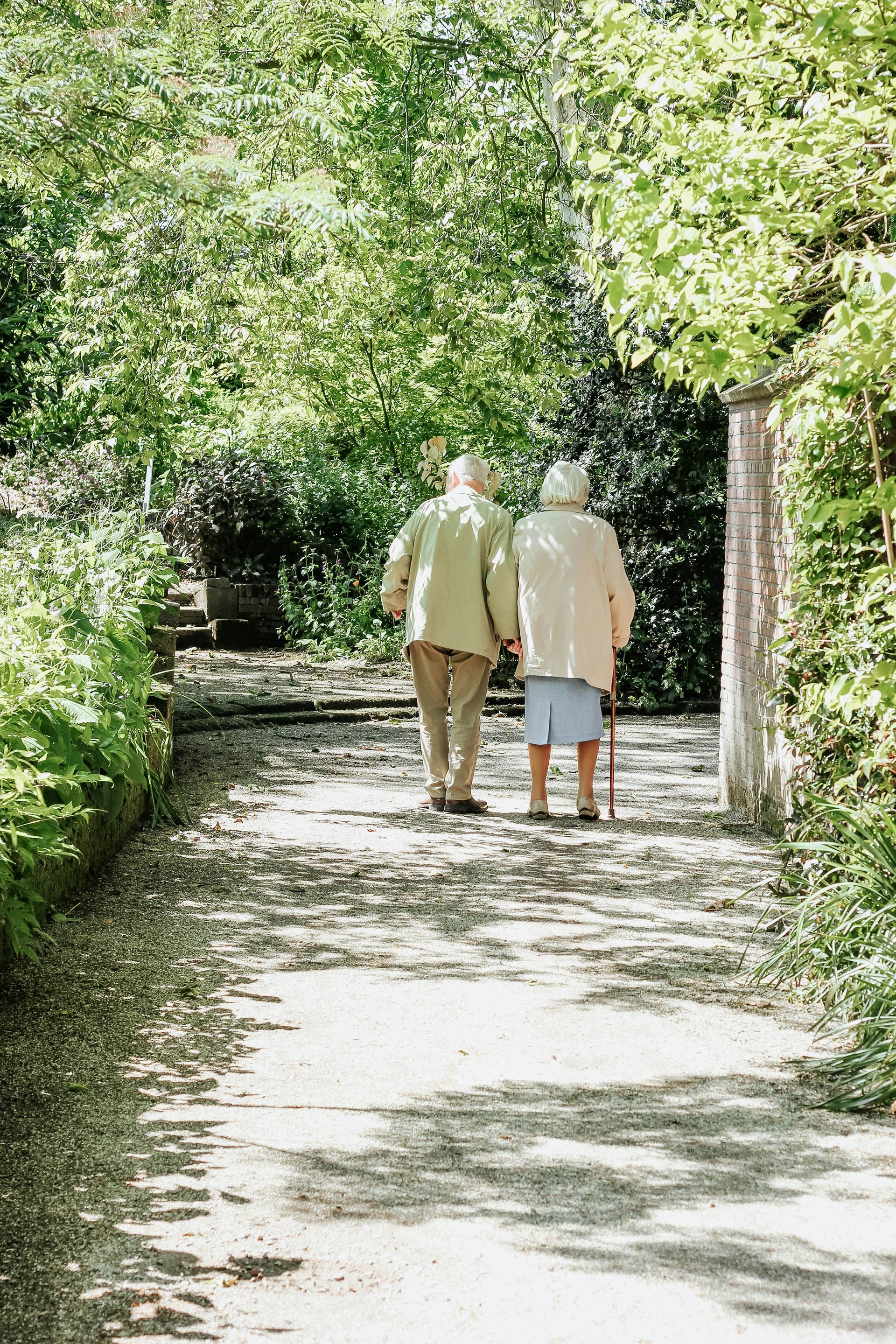 Image of two older people walking together
