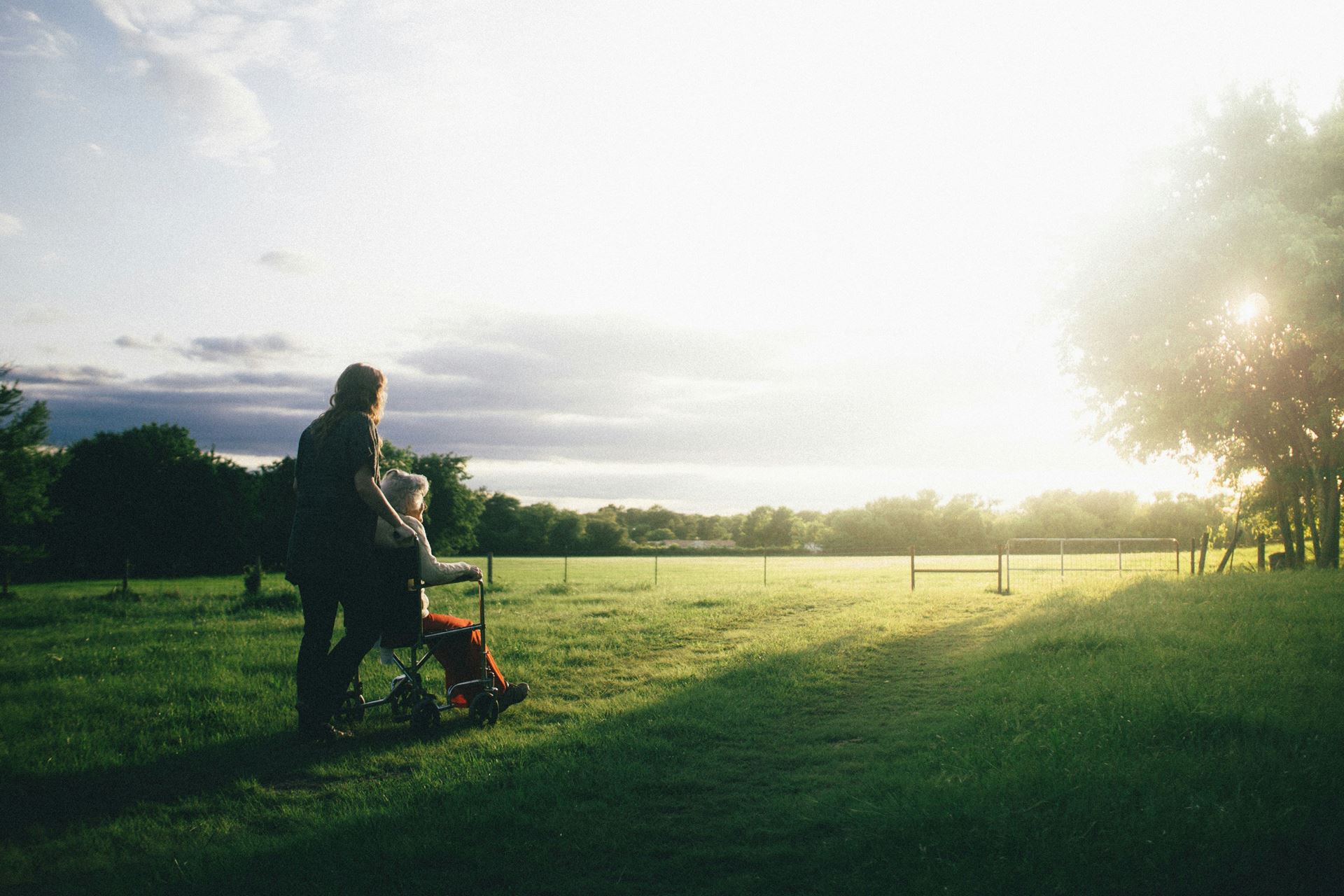 Picture of two people in a field in the sun